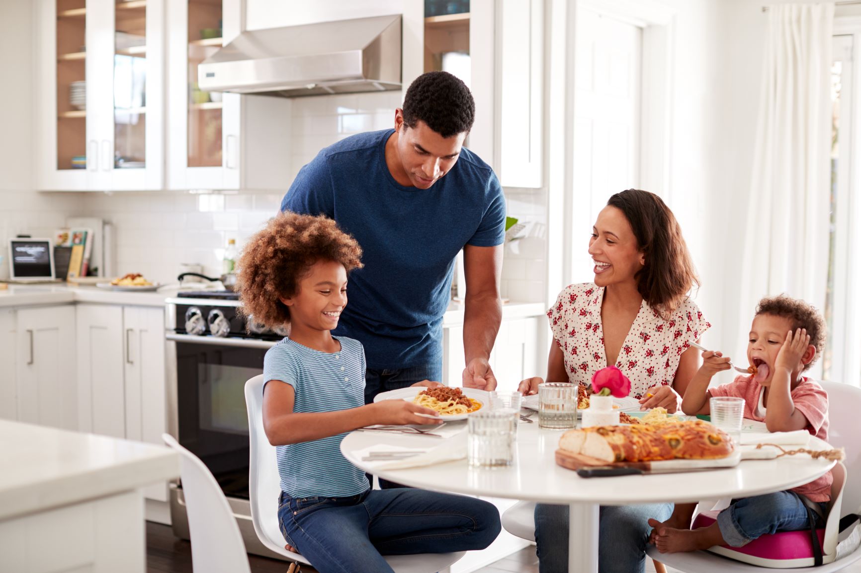 Family of four eating dinner together - Trust Marriage